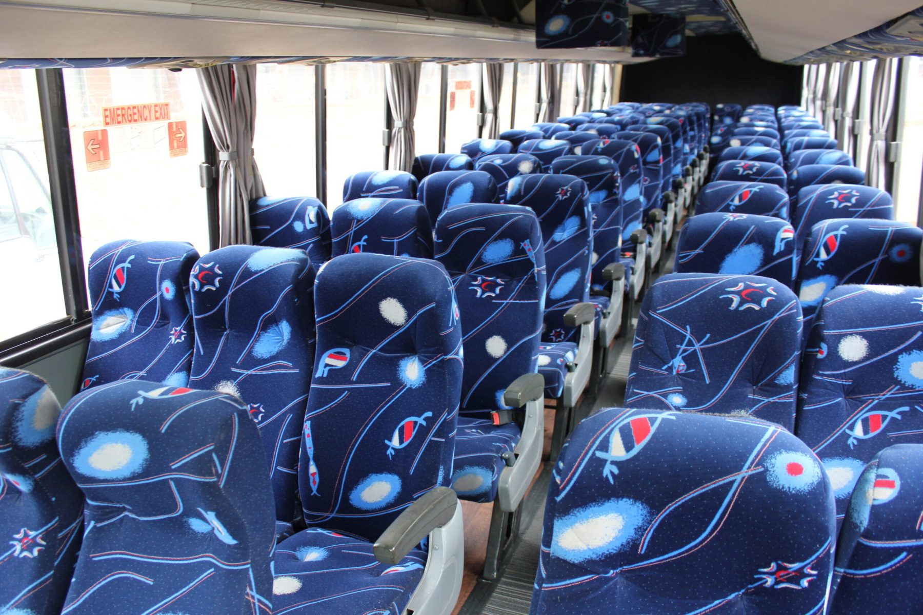 Spacious interior of our 71-seater bus available for bus hire in Johannesburg, featuring comfortable cloth seats, parcel shelves, and safety belts – perfect for school trips, events, and private group transport | TAG Passenger Services